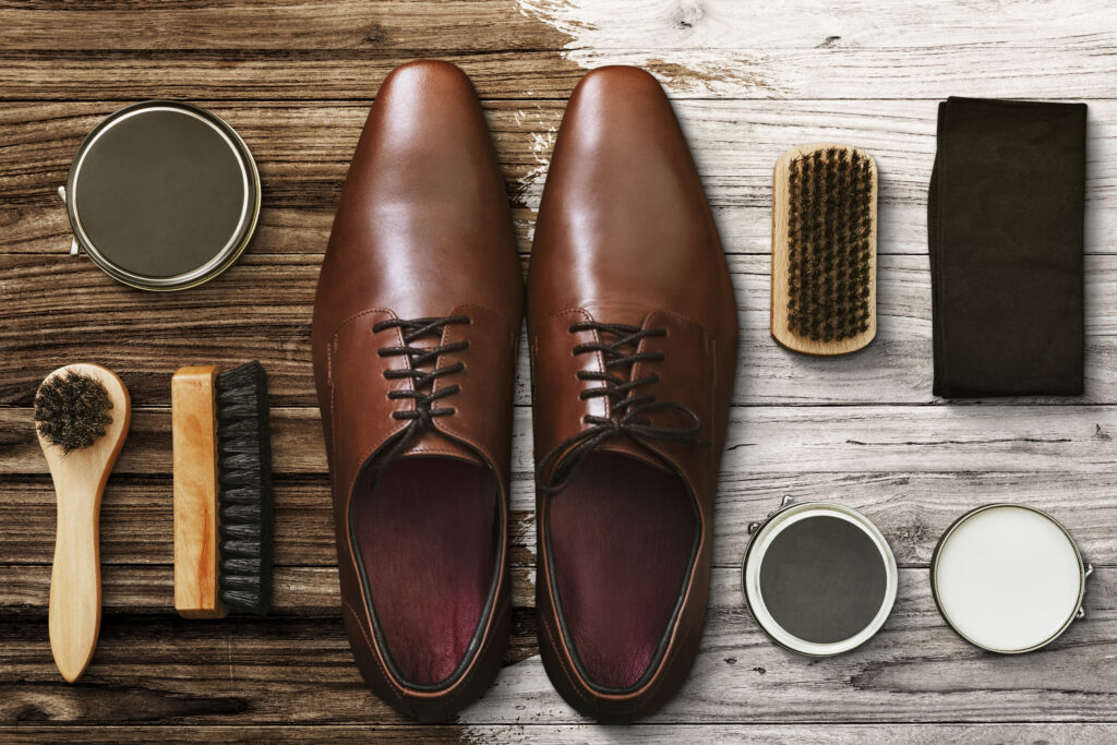 Men's leather shoes flat lay with polishing tools